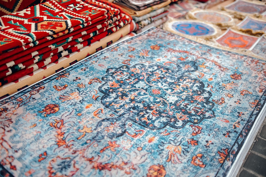 A collection of traditional handmade carpets with vibrant patterns on display.