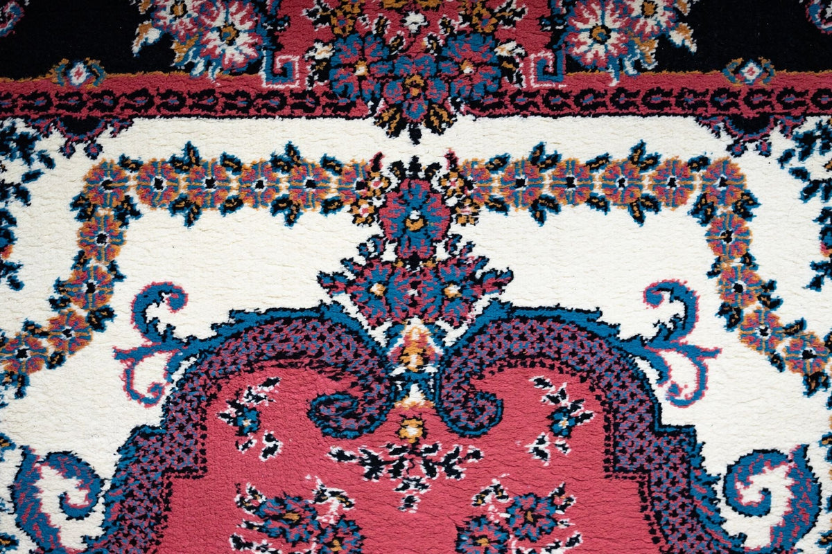 Close-up of a colorful Persian rug with intricate floral patterns and vibrant colors.