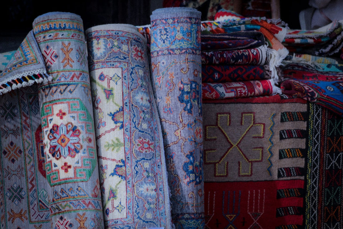 Vibrant handwoven rugs showcasing intricate designs and textures in a traditional market setting.