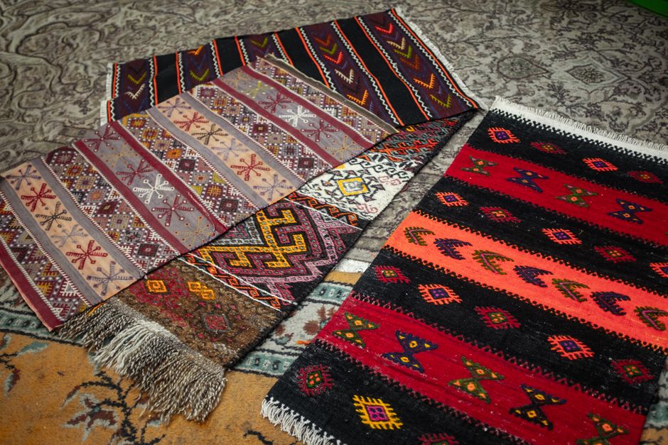 Vibrant handwoven rugs displaying intricate geometric and cultural patterns, ideal for decor.