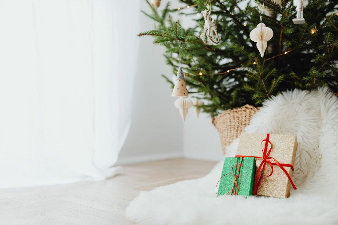 A beautifully decorated Christmas tree with wrapped gifts and cozy decor, perfect for the holiday season.